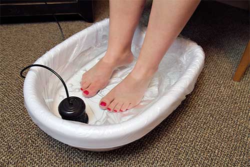 a person receiving a foot bath
